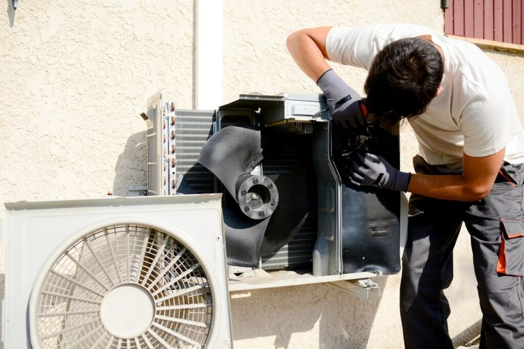 Technician servicing HVAC equipment